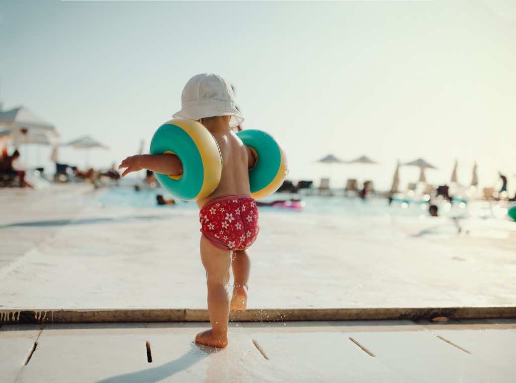 young child next to swimming pool