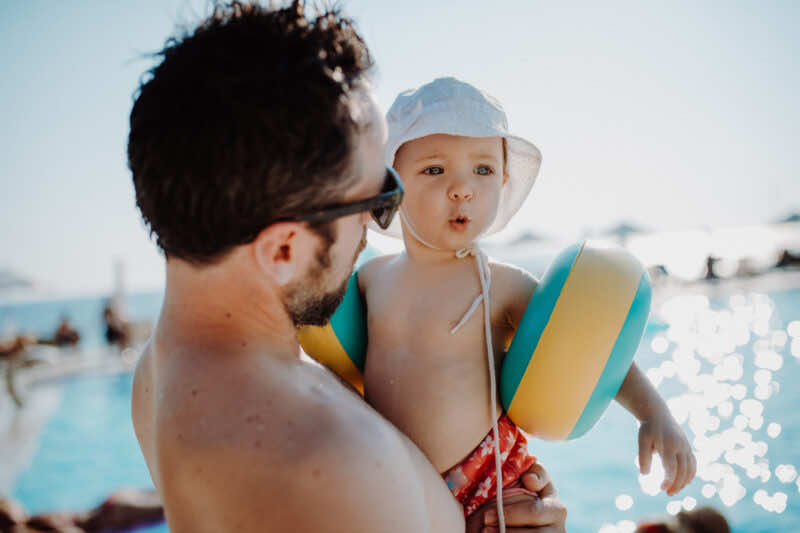 young father with child at swimming pool